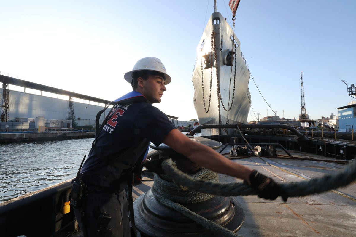 A deckhand secures a line from a cargo ship that Vinik Marine moved from the Brooklyn Navy Yard to Norfolk, Virgina.