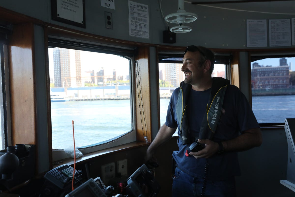 Mike Vinik stands in the pilot house of one of his tugs in New York Harbor.