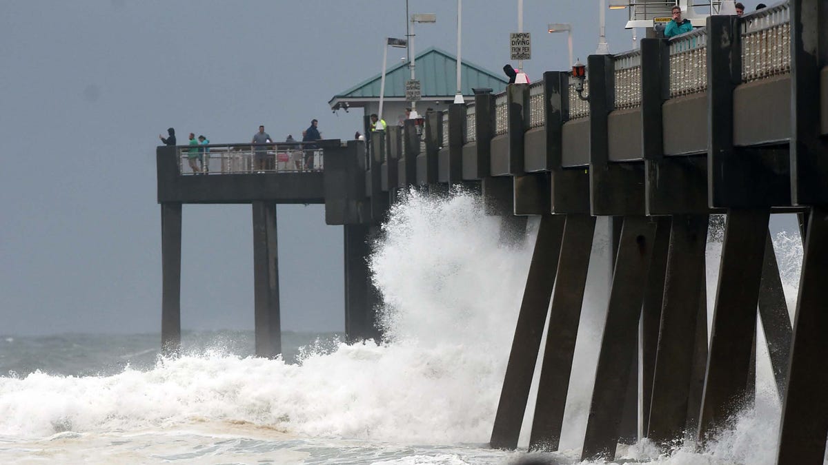 Waves crash against the Okaloosa Island Fishing pier Monday evening as wind and waves from Hurricane Sally begin to brush the Emerald Coast.