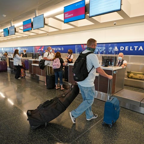 A passenger arrives at Delta's ticketing gate in t