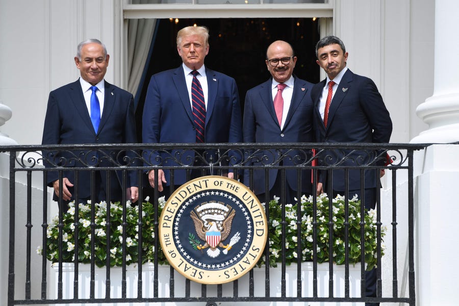 Israel Prime Minister Benjamin Netanyahu, President Donald Trump, Bahrain Foreign Minister Abdullatif al-Zayani, and United Arab Emirates Foreign Minister Abdullah bin Zayed Al-Nahyan pose from the Truman Balcony at the White House after they participated in the signing of the Abraham Accords.