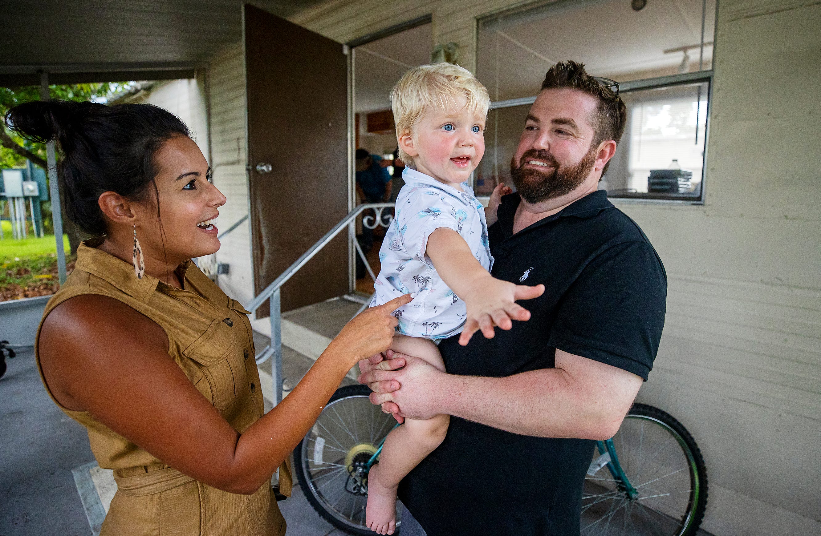 Better Together's Isis LaRose, left, and host family volunteer, Ryan Lukosavich, love on Jack during Jack's reunion with his mother Kyrstal Hartman at their new home in July. Jack lived with Ryan and his wife Chelsea while Hartman searched for a home.