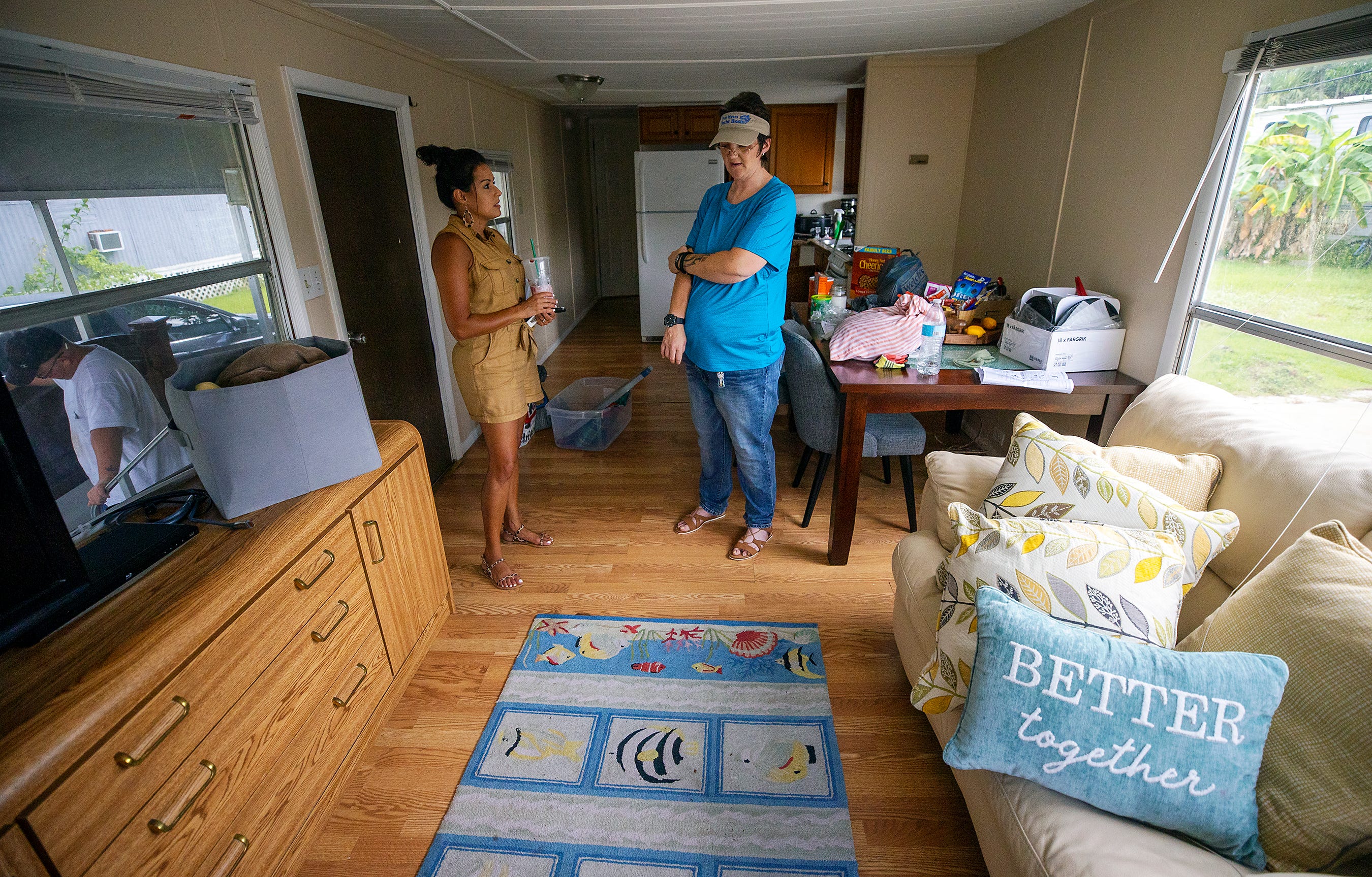 Better Together’s Isis LaRose, left, talked with Kyrstal Hartman on the day Hartman was reunited with her son, Jack, in their new home in July.