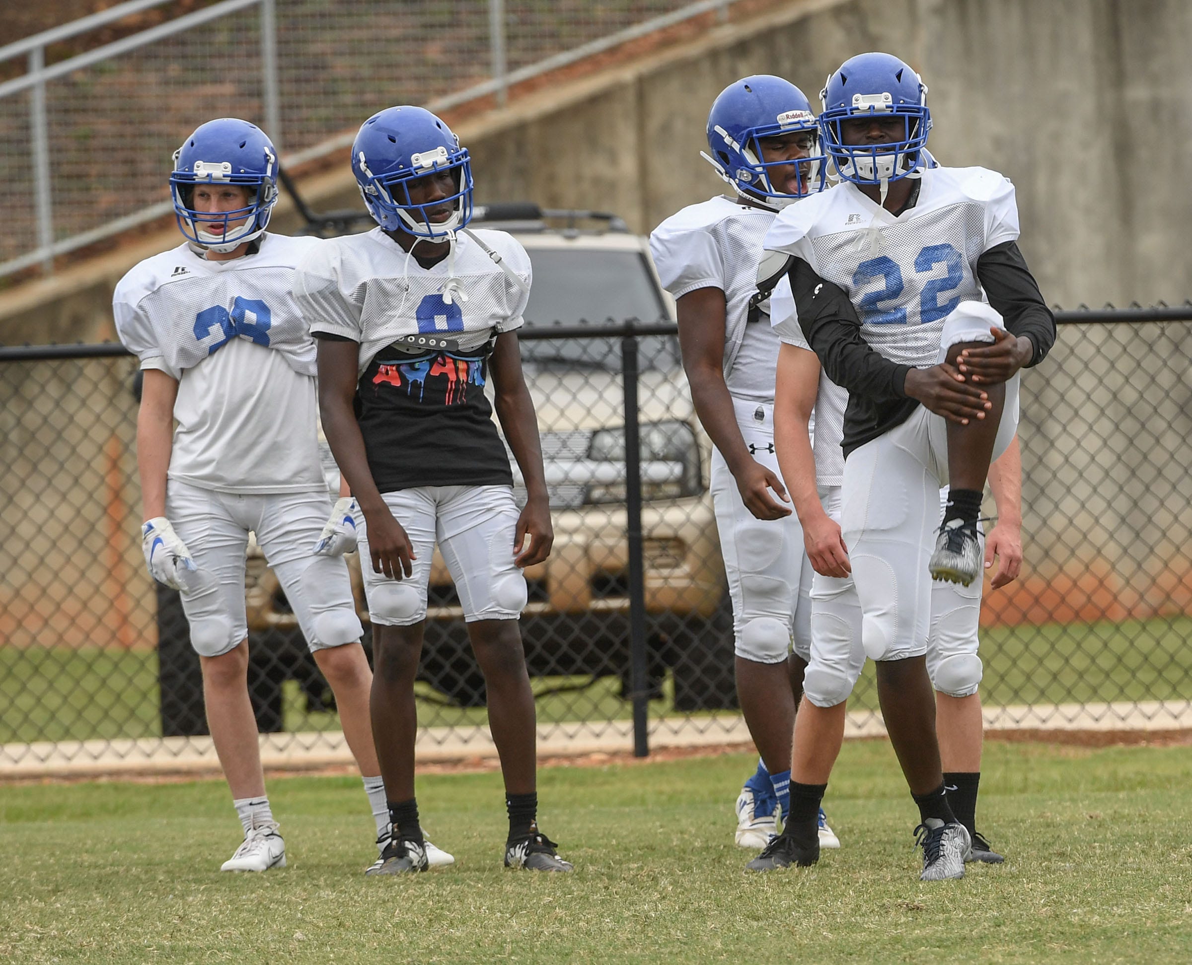 Woodmont High School football running back Joshua Kamoto, right, stretches at the beginning of practice in Piedmont, S.C. September 2020.
