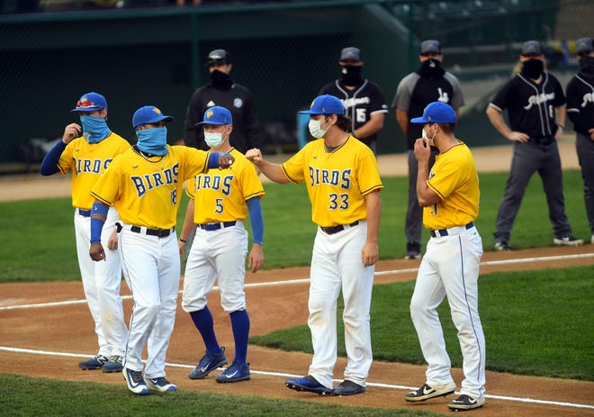 Alay Lago fist bumps his Canaries teammates during player introductions before playing the Milwaukee Milkmen in the third game of the American Association Finals on Tuesday, September 15, at the Birdcage in Sioux Falls. 
