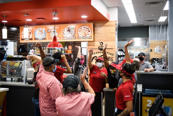 Sheetz employees do a cheer minutes before a store opening in Sept. 2020.