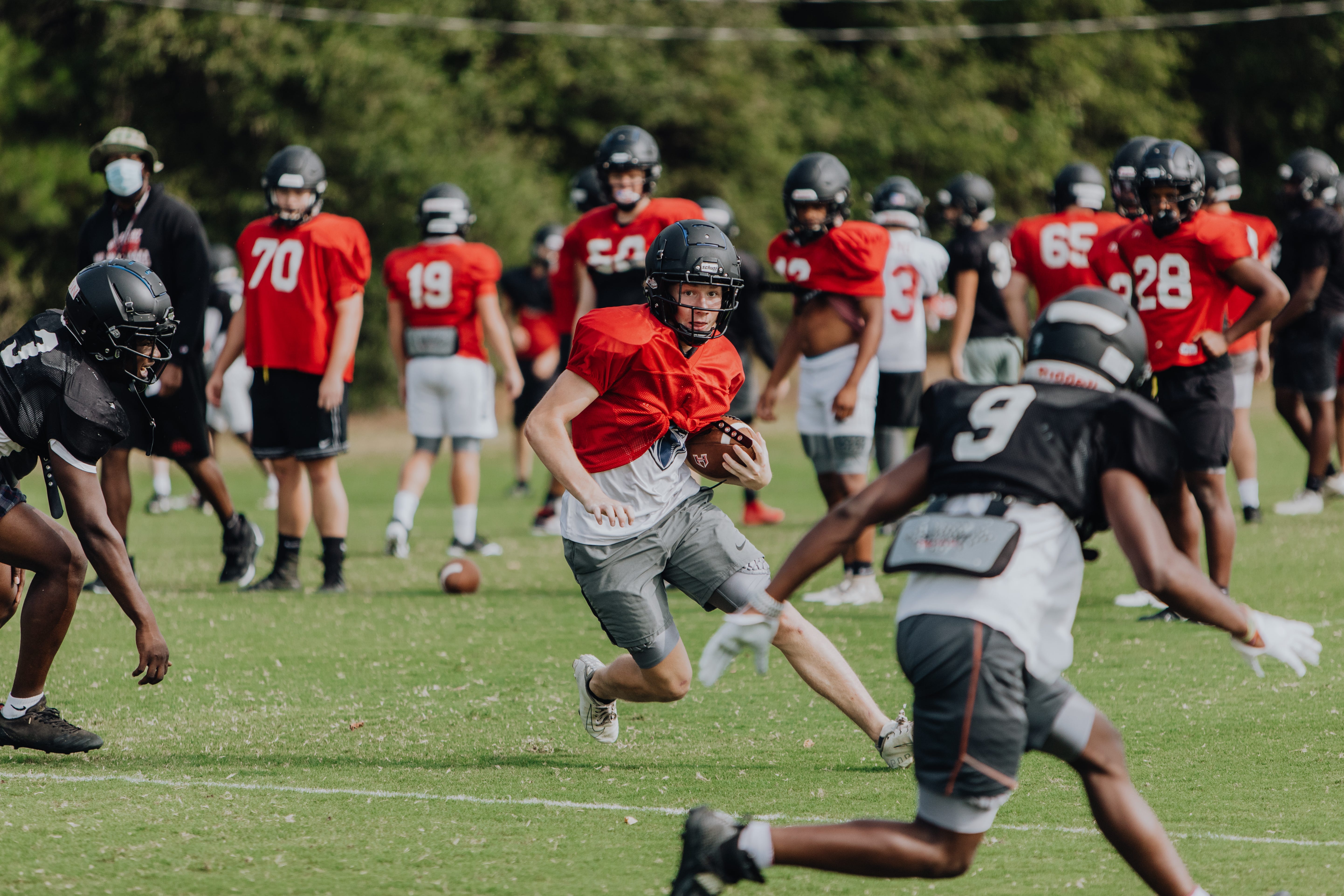 Hillcrest High School football players run through plays during practice Tuesday, Sept. 15, 2020.
