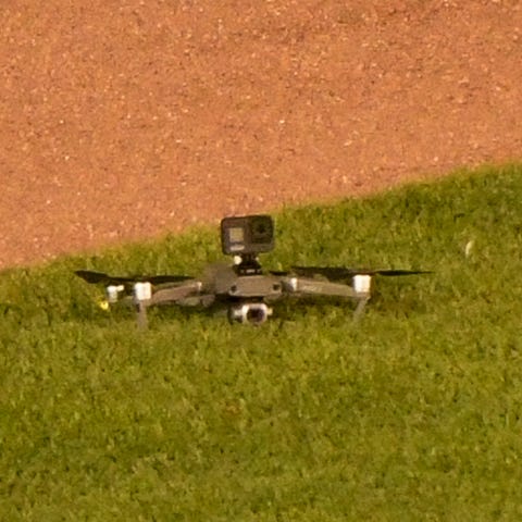 A drone lies on the grass after it landed in cente