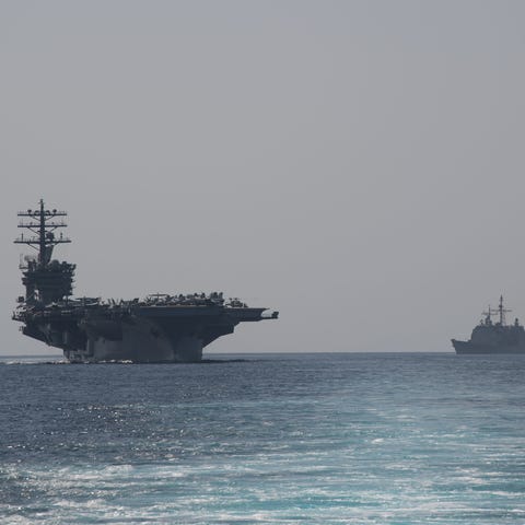 The aircraft carrier USS Nimitz, left, and the gui