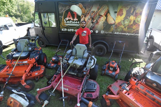 Sidney Bonham poses for a photo with his fleet of lawn care equipment and his A1 Entrees truck.