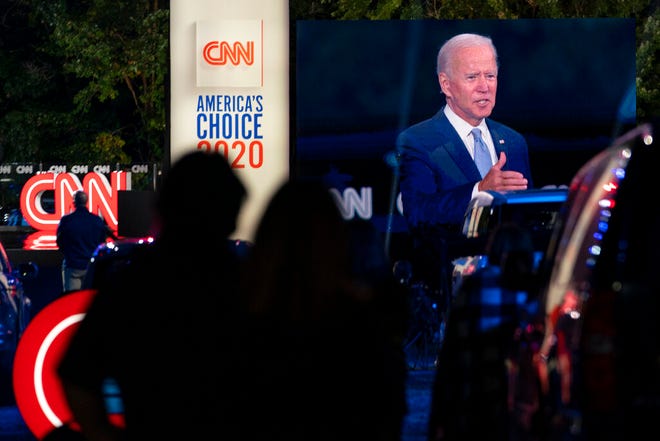 Audience members watch from their cars as Democratic presidential candidate former Vice President Joe Biden, seen on a monitor, speaks during a CNN town hall in Moosic, Pa., Thursday, Sept. 17, 2020. (AP Photo/Carolyn Kaster)