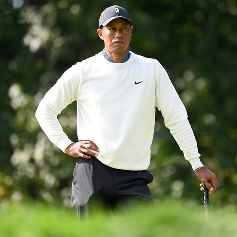 Tiger Woods looks over his shot on the 15th green 