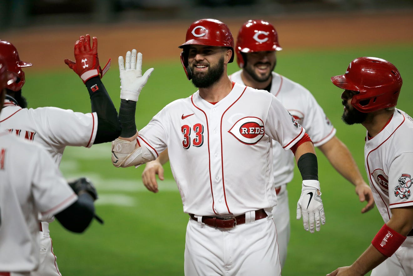 Cincinnati Reds designated hitter Jesse Winker (33) celebrates a three-run home run in the third inning of an MLB Interleague game between the Cincinnati Reds and the Chicago White Sox at Great American Ball Park in downtown Cincinnati on Friday, Sept. 18, 2020.