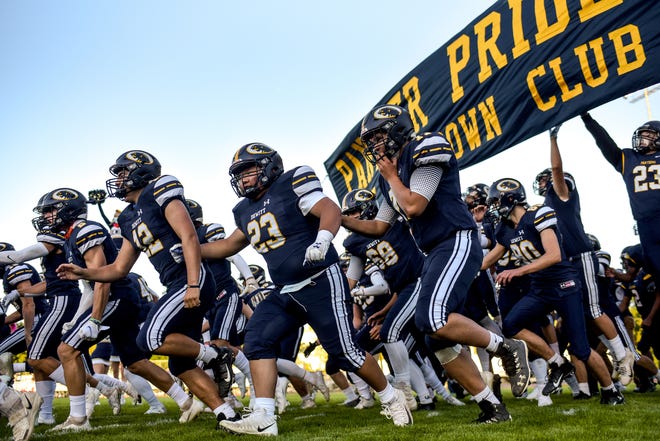 The DeWitt football team takes the field before their Panthers game against Portland on Friday, Sept. 18, 2020, at DeWitt High School.