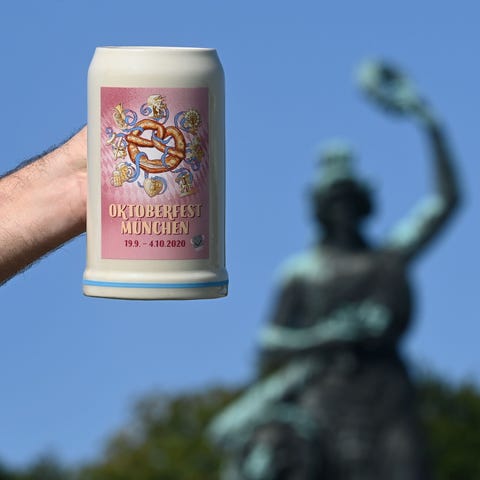 A man holds up the official 2020 Oktoberfest beer 