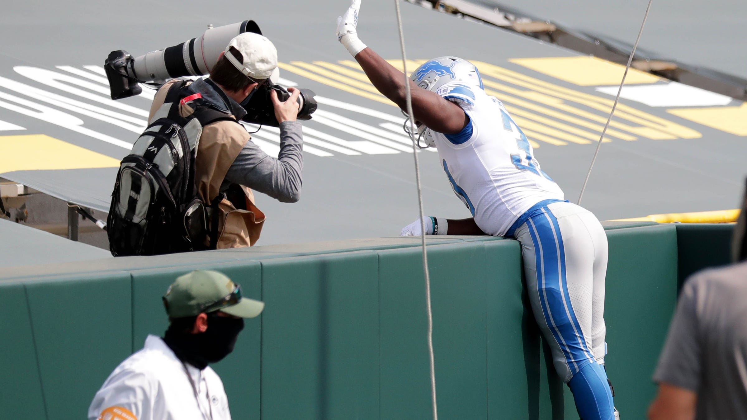 Detroit Lions running back Kerryon Johnson (33) celebrates a touchdown by jumping into the stands with no fans during the first quarter of the Green Bay Packers play the Detroit Lions at Lambeau Field in Green Bay on Sunday, Sept. 20, 2020.