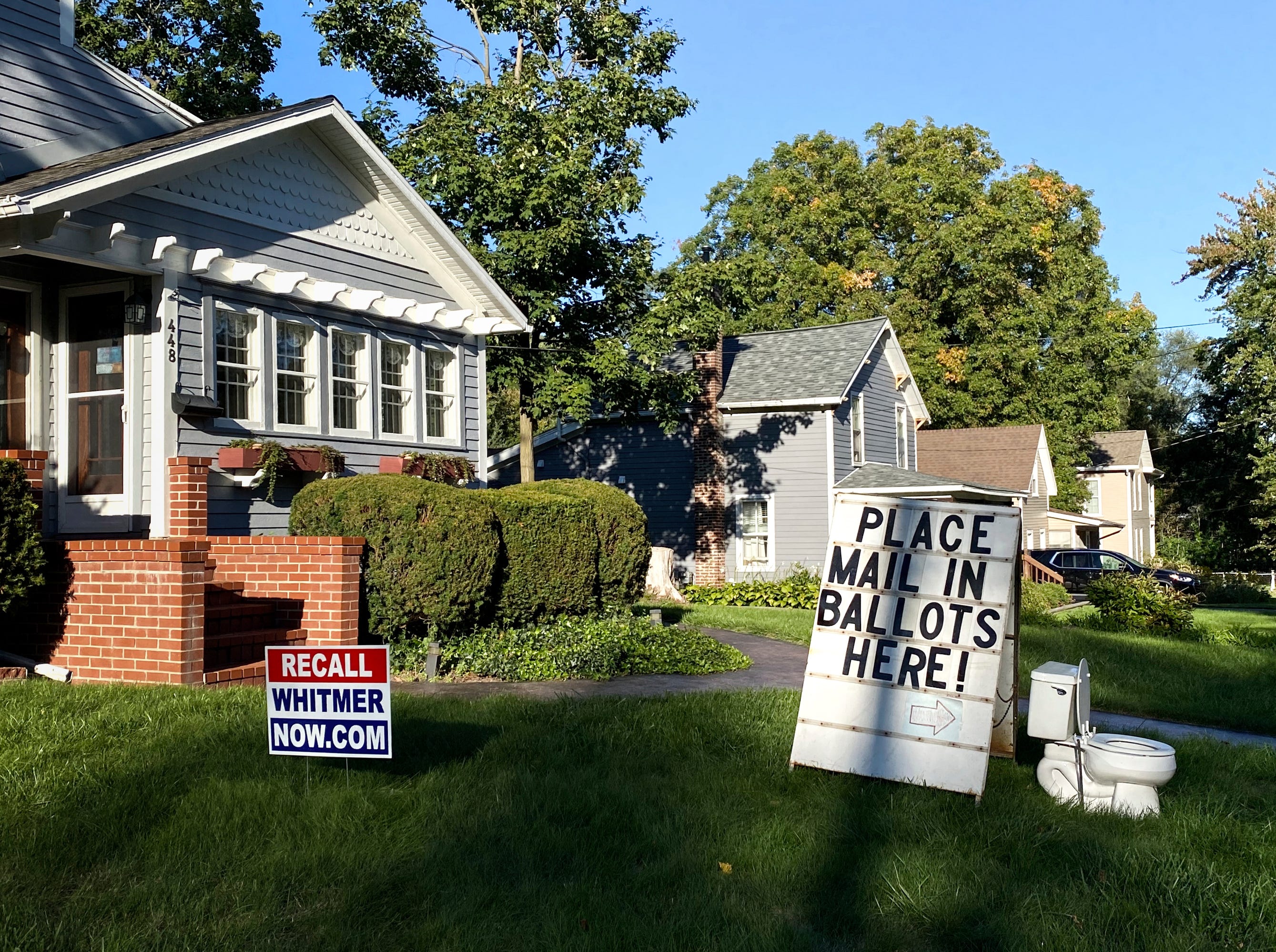 A political display is set up in the lawn of a home in Mason, Mich., seen Friday, Sept. 18, 2020.