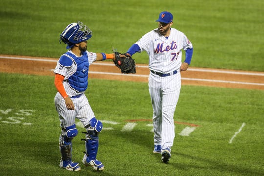 Sep 19, 2020; New York City, New York, USA;  New York Mets catcher Robisnon Chirinos (26) greets pitcher David Peterson (77) retiring the side in the fourth inning against the Atlanta Braves at Citi Field.