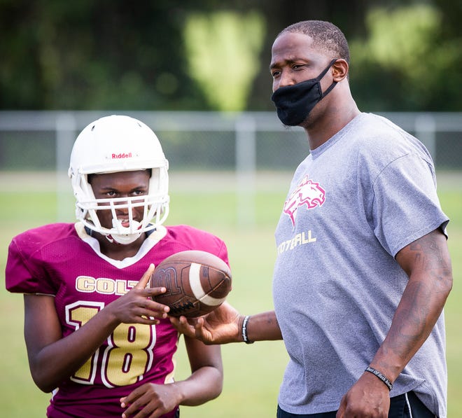 North Marion's first-year head football coach Greg Carr leads his team in football practice Monday afternoon. The Colts open up their season against Forest on Friday.