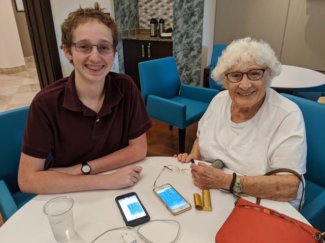 Tech expert Joshua Thaw provides one-on-one iPhone support as part of South Florida Tech For Seniors' in-person services. In the wake of the pandemic, the nonprofit has transitioned to remote technology support.