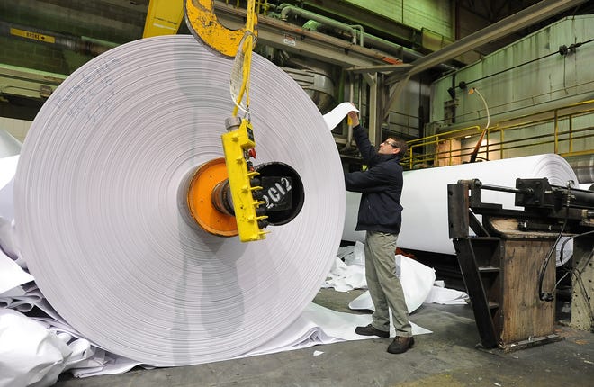 In this 2009 file photo, an Evergreen Packaging supervisor works in the roll wrap area at Evergreen Packaging in Canton. The mill produces paper for liquid packages and cups, as well as commercial paper.