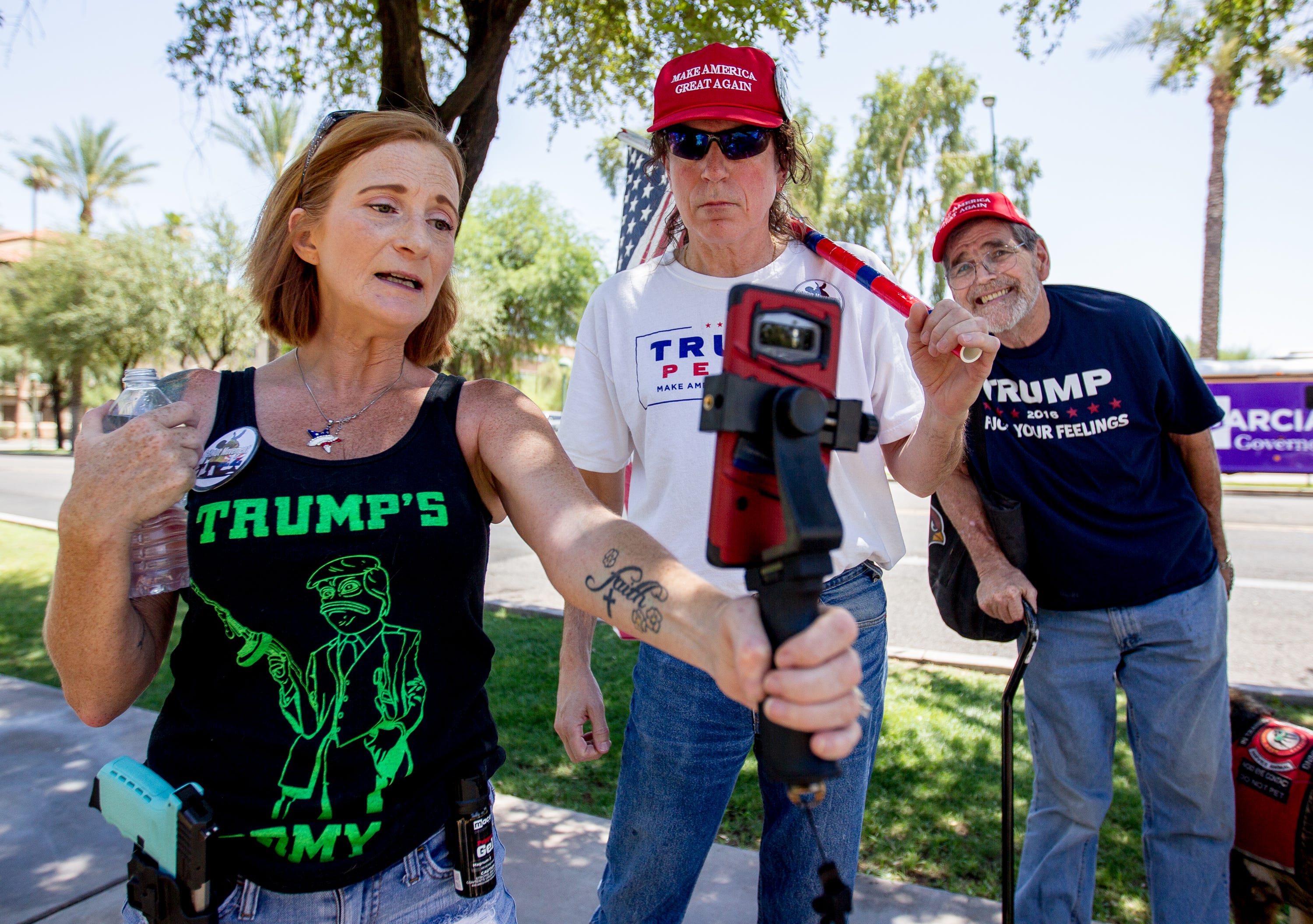 Lesa Antone (left) of the Patriot Movement AZ group livestreams while counterprotesting the #RedForEd movement on June 23, 2018.