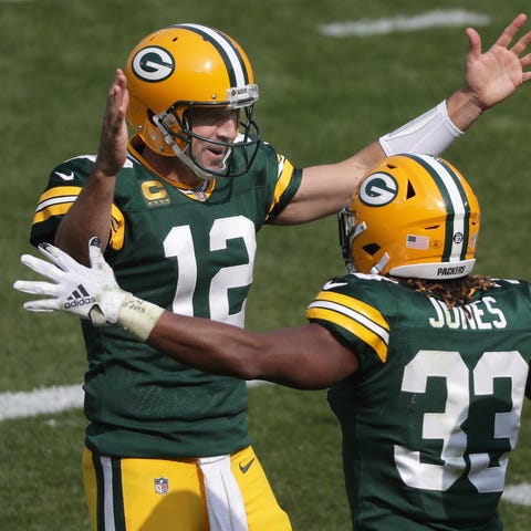 Green Bay Packers quarterback Aaron Rodgers runnin