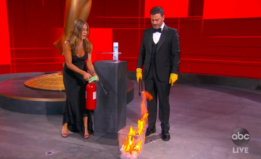 Jennifer Aniston, and Jimmy Kimmel "sanitize" the winner's envelope while presenting the award for outstanding lead actress in a comedy series during the 72nd Emmy Awards broadcast.