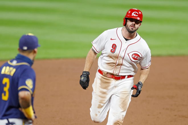 Mike Moustakas is back for a second season with the Cincinnati Reds after two playoff runs with the Milwaukee Brewers.