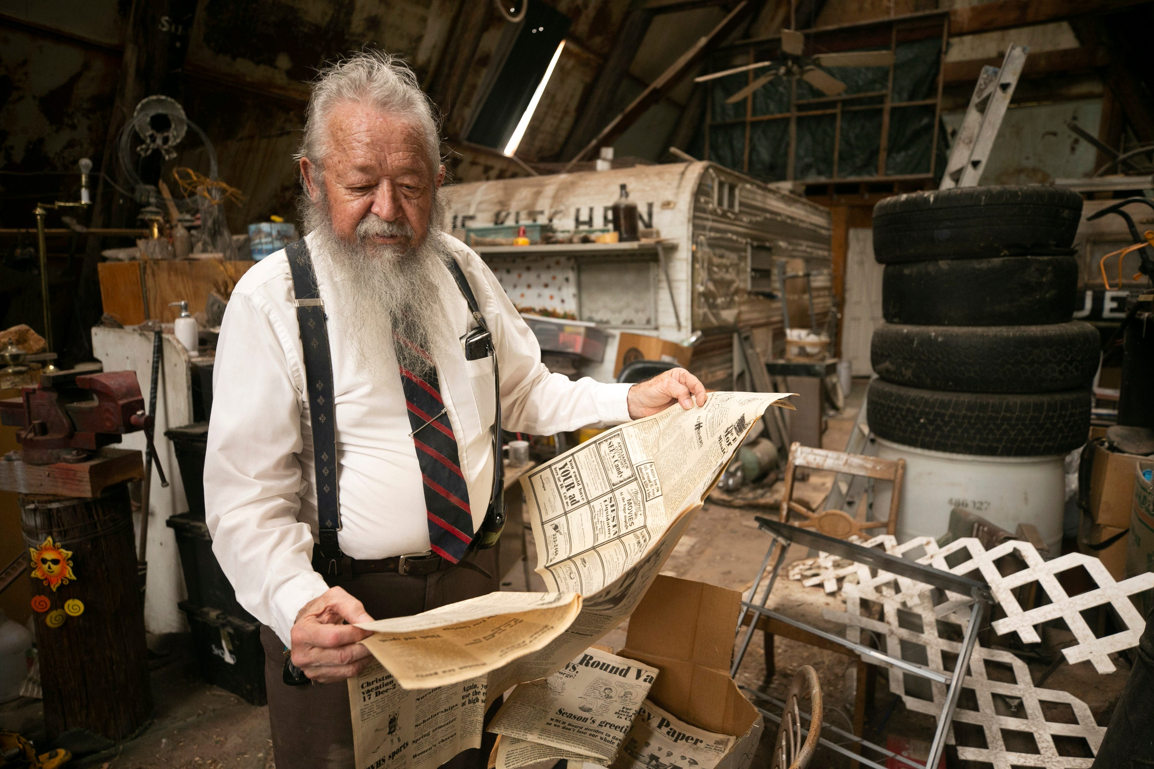 Glenn Jacobs, the former editor and publisher of The Round Valley Paper, looks at the paper in the barn on his property in Eagar on Aug. 19, 2020.