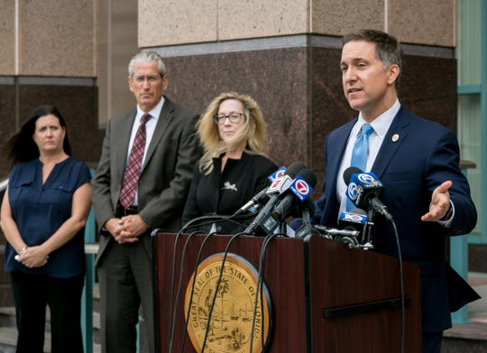Palm Beach County State Attorney Dave Aronberg speaks to the media with assistants (l to r) Judy Arco, Al Johnson, and Elizabeth Neto, about charges in recent prostitution investigations outside his offices Monday in West Palm Beach.  [RICHARD GRAULICH/palmbeachpost.com]