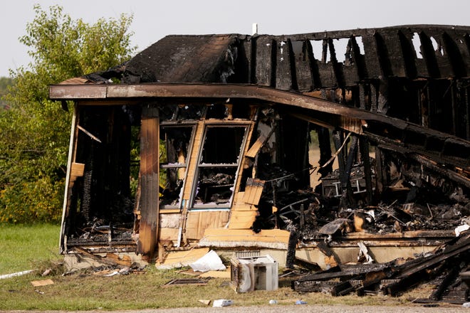 The charred structure of a house on the 2700 block of South Indiana 29, Wednesday, Sept. 23, 2020 in Carroll County. Officials say two people, a man and woman, were found dead inside the house, located north of Burlington. The woman, Anna Downham, 35, officials say had been killed before the fire started in the house.