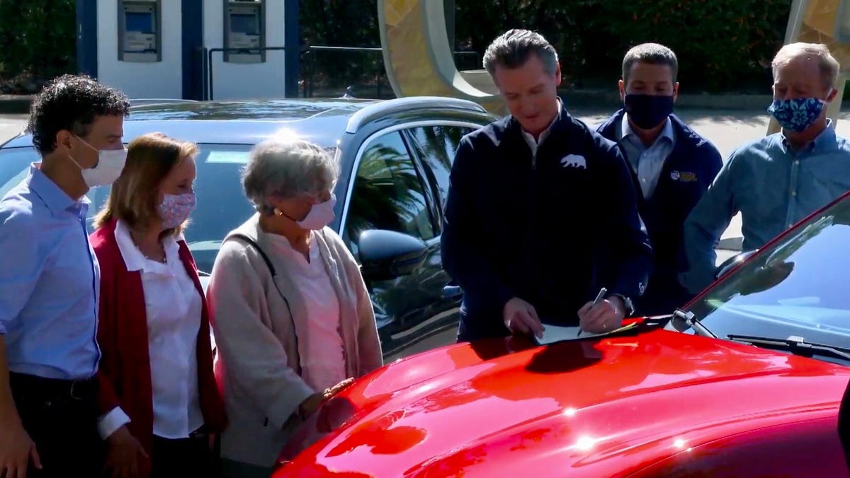 Gov. Gavin Newsom signs an executive order concerning electric vehicles on Sept. 23, 2020.