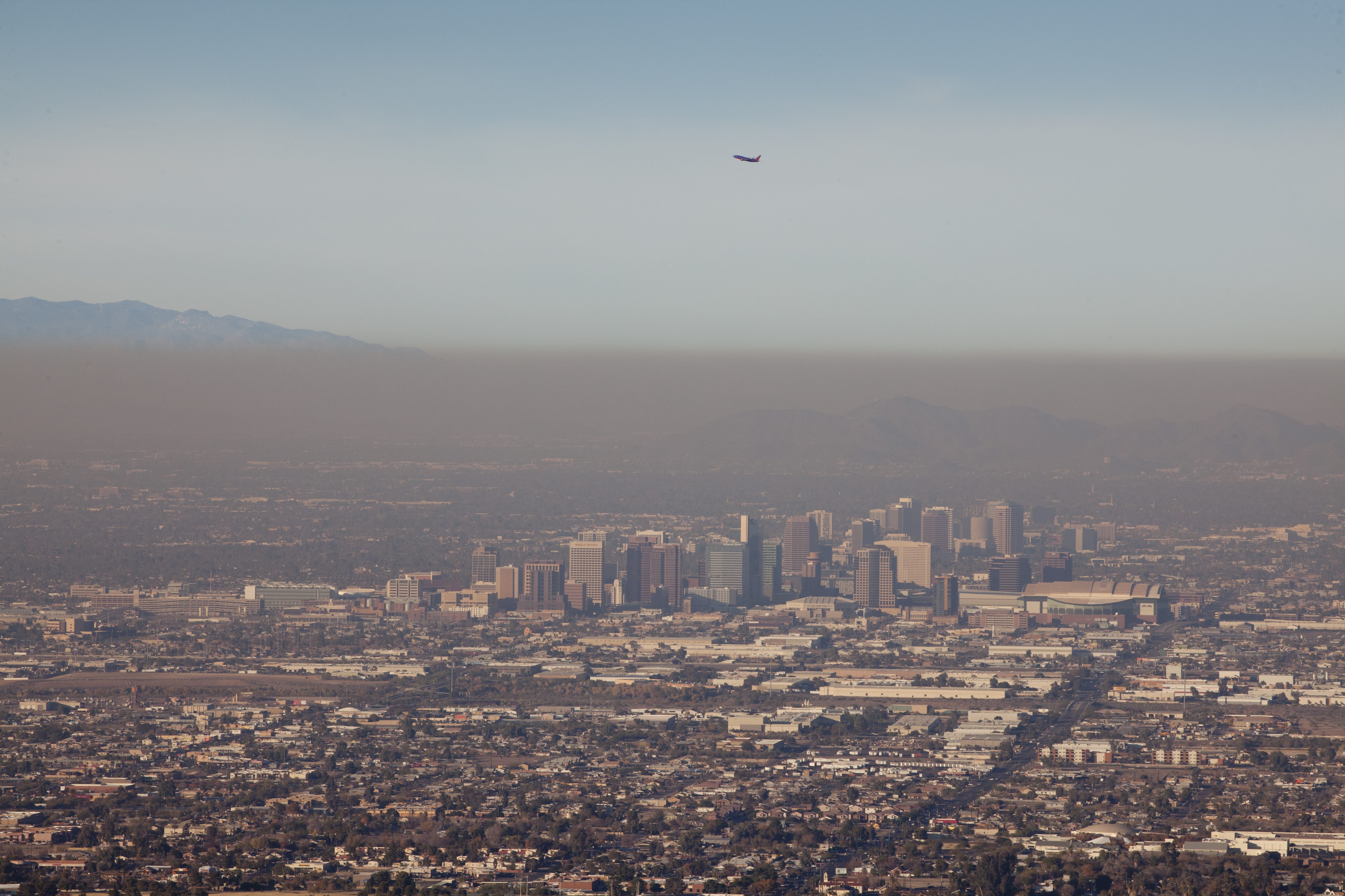 A brown cloud hangs over Phoenix, pollution fed in part by vehicle traffic.