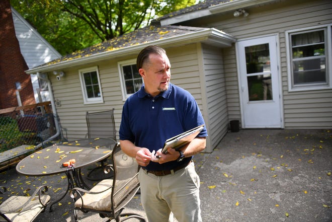 Jason Tangen of Shrewd Real Estate checks on details of a property with a homeowner during a listing appointment Tuesday, Sept. 22. 2020, in St. Cloud. 
