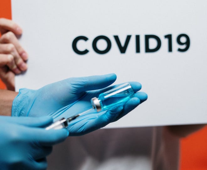 Syringe and COVID-19 sign.