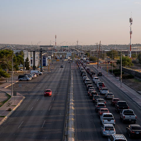 Thousands of vehicles wait to cross into the Unite