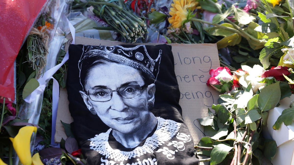 Signs and flowers are left at a makeshift memorial in front of the U.S. Supreme Court for the late Justice Ruth Bader Ginsburg September 21, 2020 in Washington, DC. Justice Ginsburg died last Friday from complications of pancreatic cancer at the age of 87.