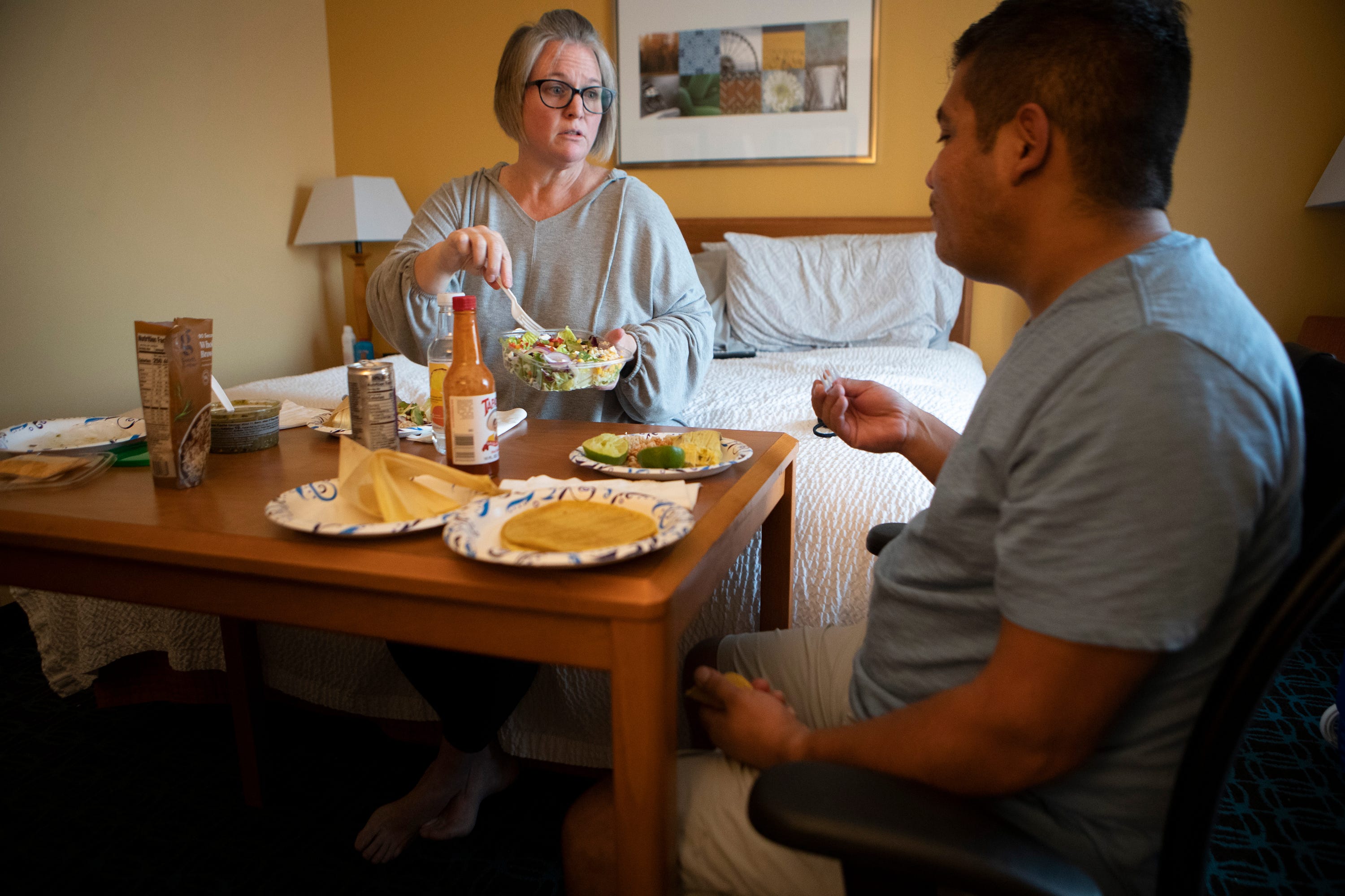 Evacuees from the El Dorado Fire, Malissa and Joaquin Lopez, eat dinner inside the San Bernardino, Calif., hotel they've been staying in for two weeks on September 22, 2020. The couple had just bought a new home in the Angelus Oaks area only four weeks before the fire broke out.