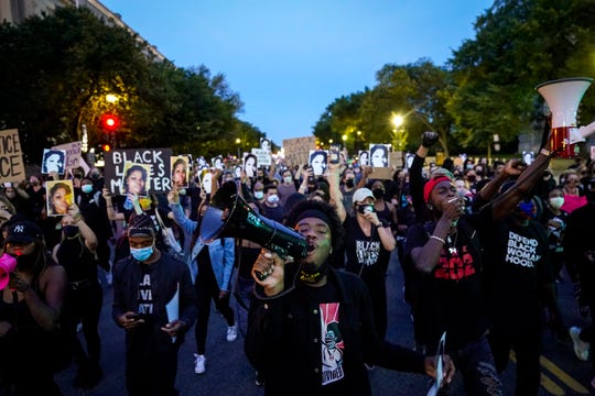 Demonstrators march along Constitution Avenue in protest following a Kentucky grand jury decision in the Breonna Taylor case.
