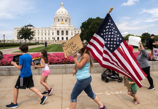 People march during a "Save the Children" rally outside the Capitol building on Aug. 22 in St Paul, Minnesota.