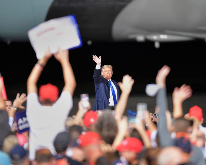 President Donald Trump waves to the crowd as he leaves Thursday at the "Great American Comeback" event at the Cecil Commerce Center.