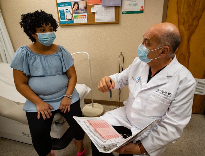 Dr. Ezer Ojeda chats with patient Zuleyka Sanchez in the Obstetrics & Gynecology clinic at Central Florida Health Care in Lakeland.