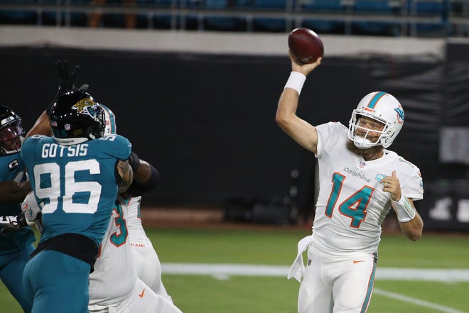 Miami Dolphins quarterback Ryan Fitzpatrick (14) throws a pass against the Jacksonville Jaguars during the first half of an NFL football game, Thursday, Sept. 24, 2020, in Jacksonville, Fla.