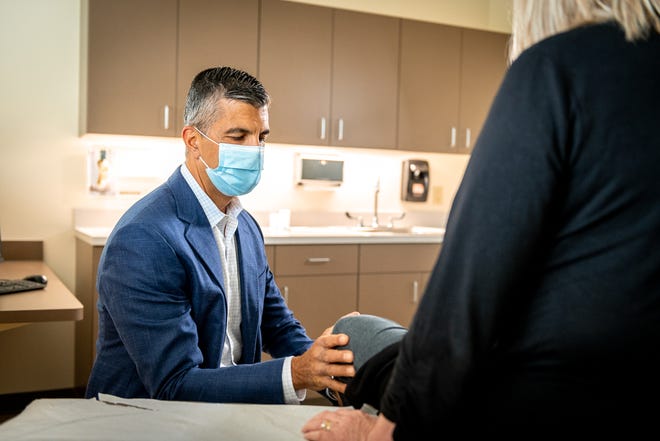 Dr. Haleem Chaudhary examining a patient.
