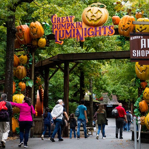 Dollywood guests walk through an entrance way for 