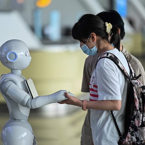 Robots roam airports reminding passengers to put t