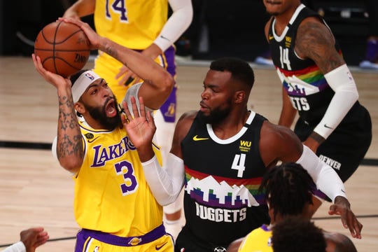 Los Angeles Lakers forward Anthony Davis shoots over Denver Nuggets forward Paul Millsap during the first half of Game 4 of the Western Conference finals.