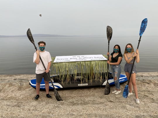 Students Evalyn Garcia, Layton Jones and Clay Jones pose with their three-person kayak. The three students plan to paddle across the Salton Sea on Aug. 26, 2020.
