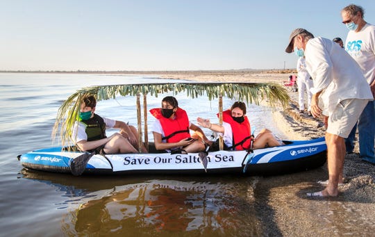 Layton Jones, 17, points toward the direction she, Evelyn Garcia, 17, center, and her brother Clayn Jones, 16, plan to kayak across the Salton Sea to raise awareness for saving the sea. The trio launched their kayak on Saturday morning from Desert Shores, Calif., on September 26, 2020.